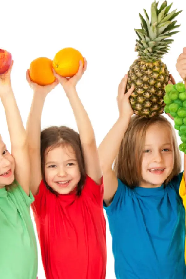 3 kids holding fruits over their heads