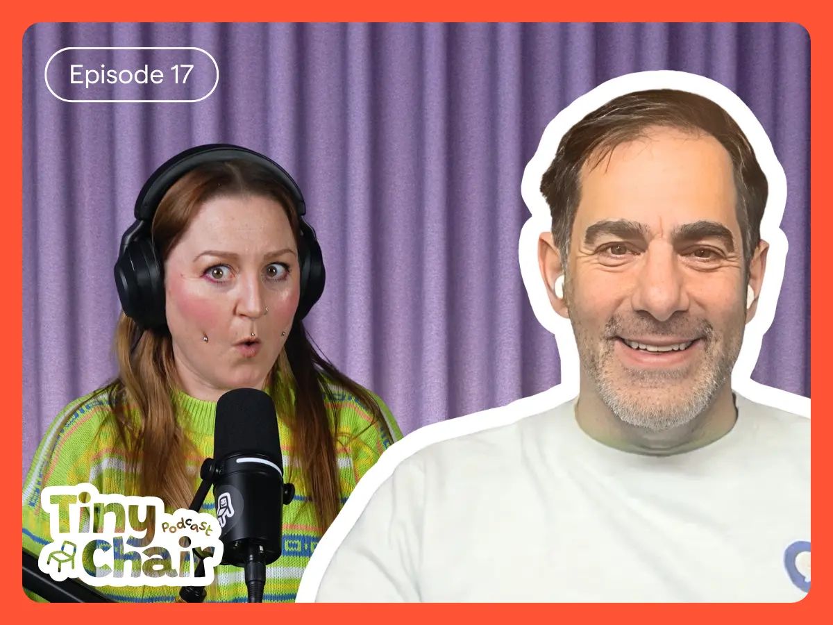 Tiny Chair Podcast host Julia with guest, Brett Wigdortz, and a purple curtain as a background