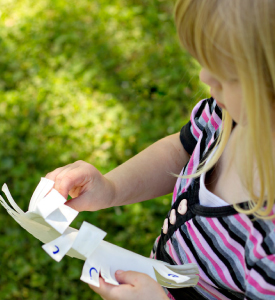 A girl with a paper plate in her hands.