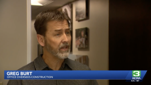 Close-up of Greg Burt speaking in a TV interview; lower third displays his name and title: 'Greg Burt, Office Oversees Construction' on KCRA