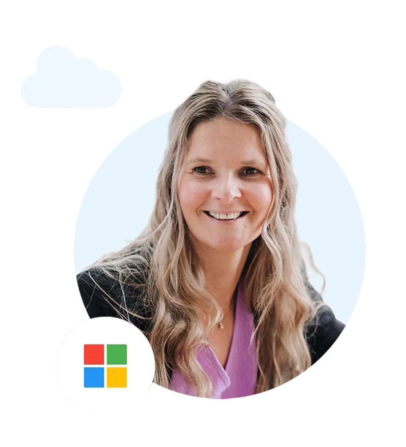 Smiling woman with long blonde hair wearing a purple top and black jacket, with a Microsoft logo in the lower left.