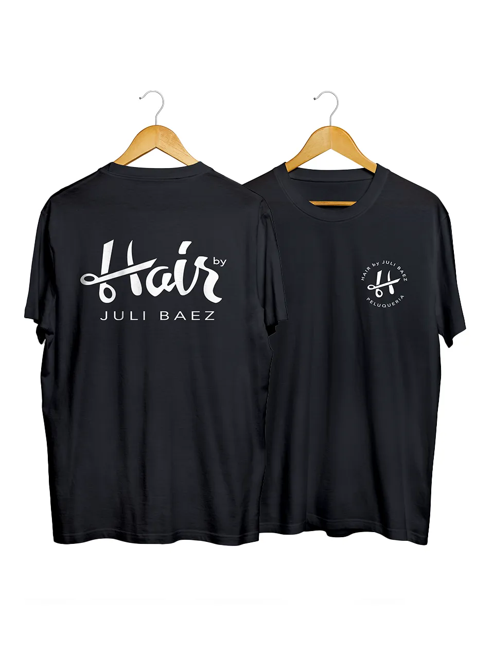 Black T-shirts on wooden hangers with Hair by Juli Baez salon logo in white on front and back.