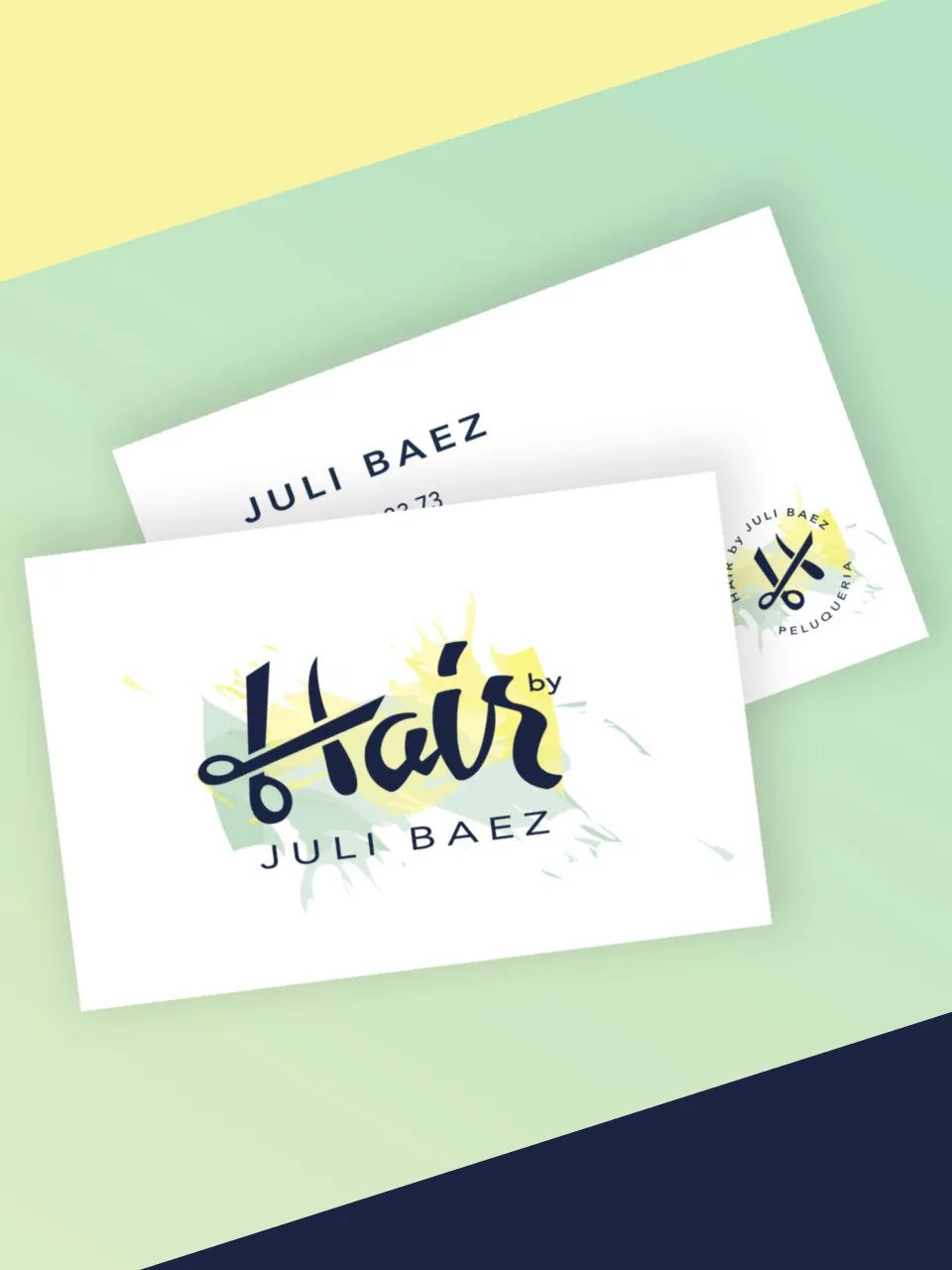Business cards for hair stylist Juli Baez featuring scissors logo and elegant typography.