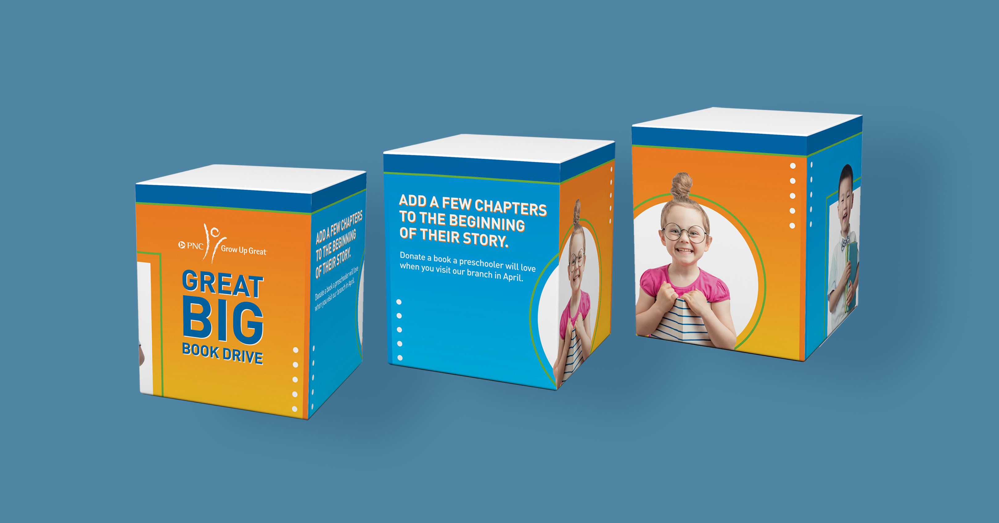 A mockup of a cube-shaped box from three different angles, over a blue background. The sides of the box alternate from a yellow-orange gradient to a teal-blue gradient. The main side features copy that reads "Great Big Book Drive," and two of the sides features images of children holding books and smiling, overlaid on white shapes. The top of the box has a thick, dark blue border.