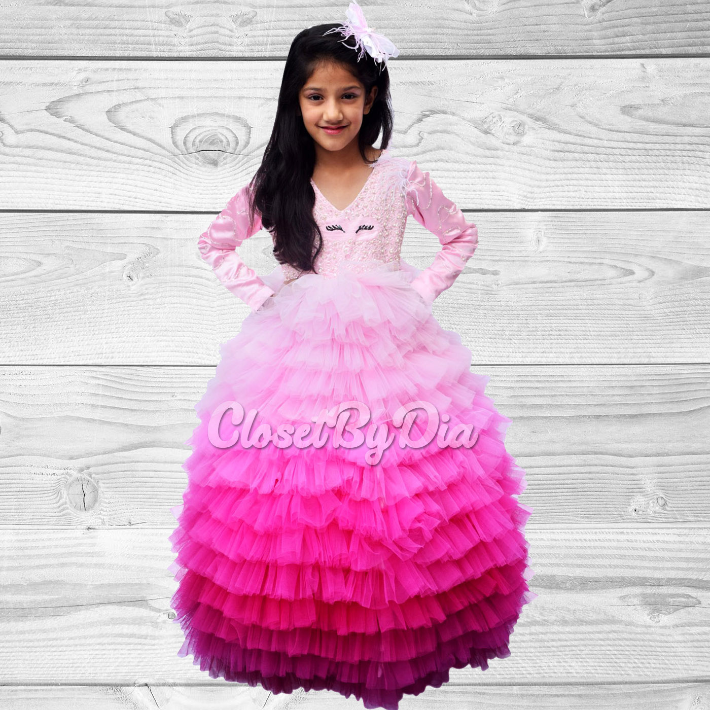 Baby girl dressed in a pink first birthday outfit with matching headband, perfect for photoshoots and celebrations