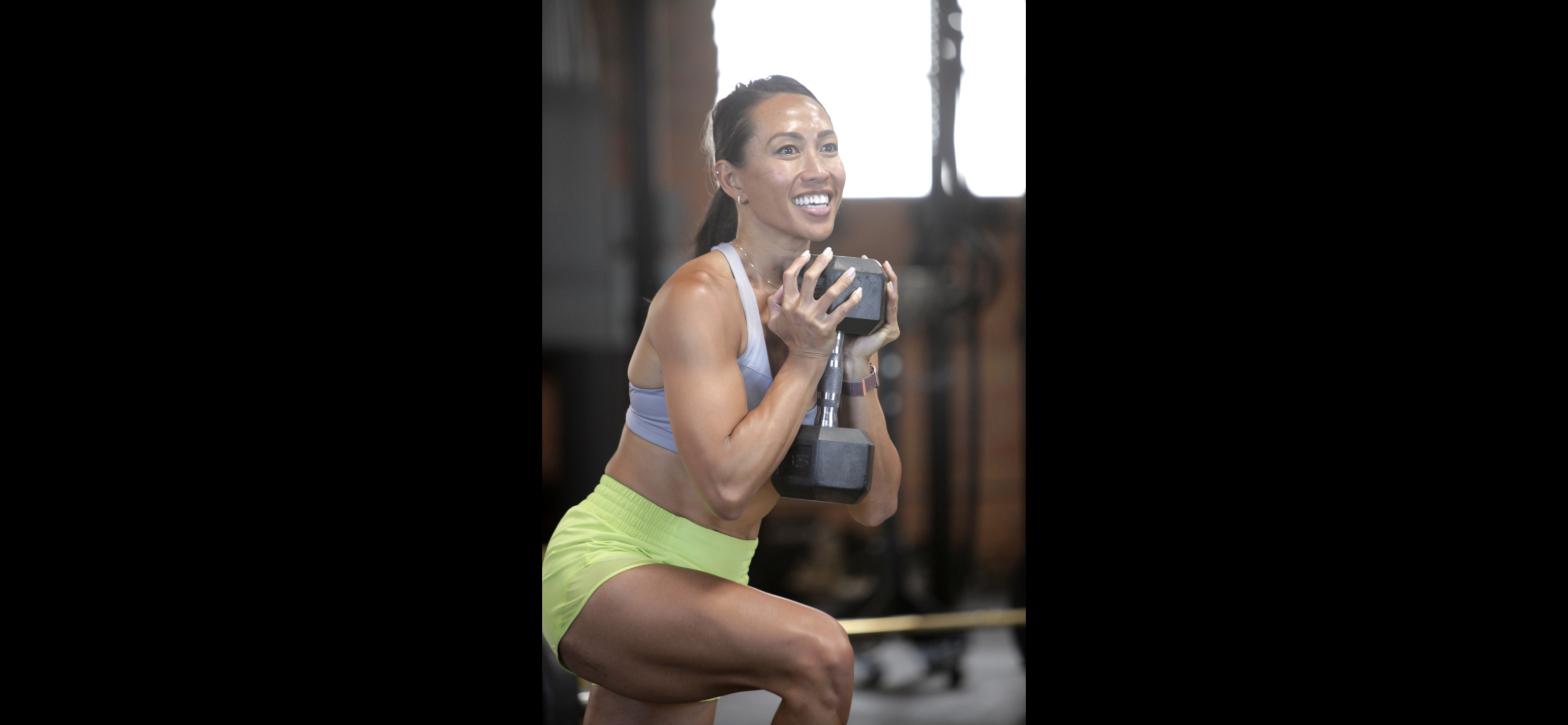 Woman training with dumbbells at West LA Athletics, a CrossFit gym in West Los Angeles.