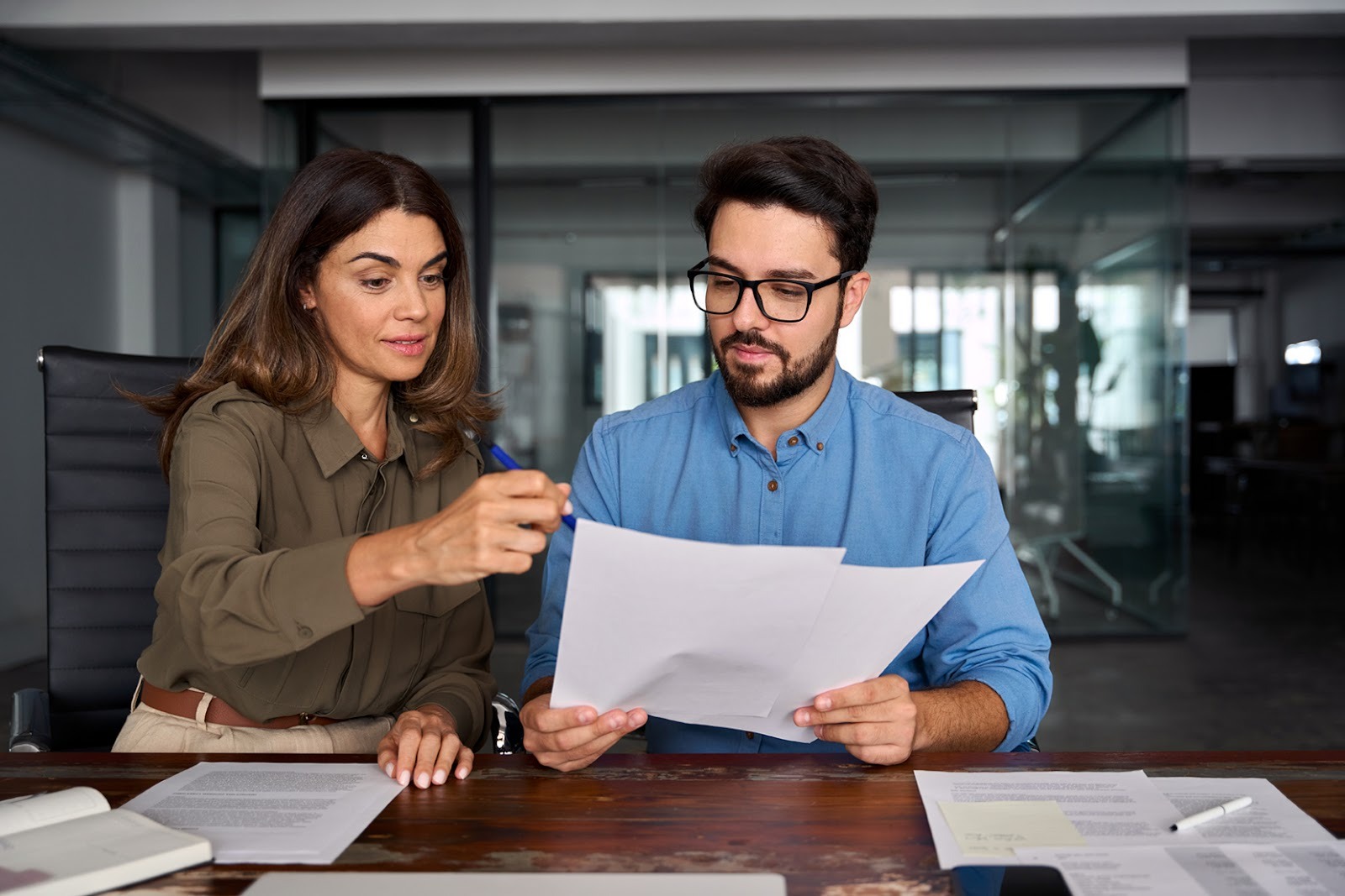 Two coworkers looking at documents