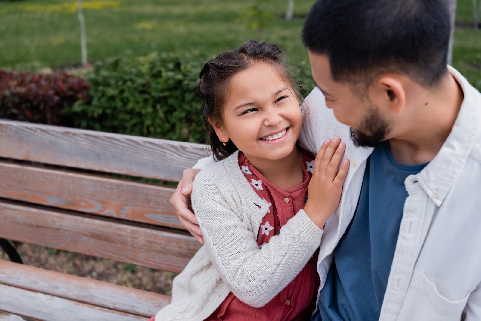 Father and young daughter embracing