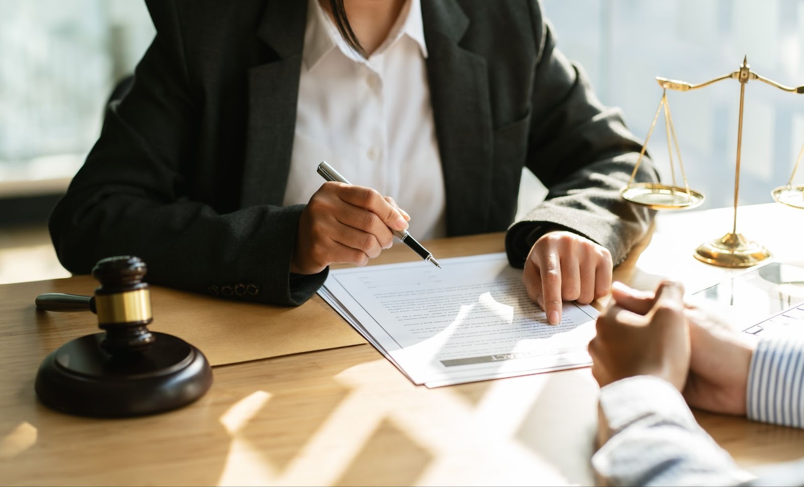 A lawyer and their client discussing paper work.