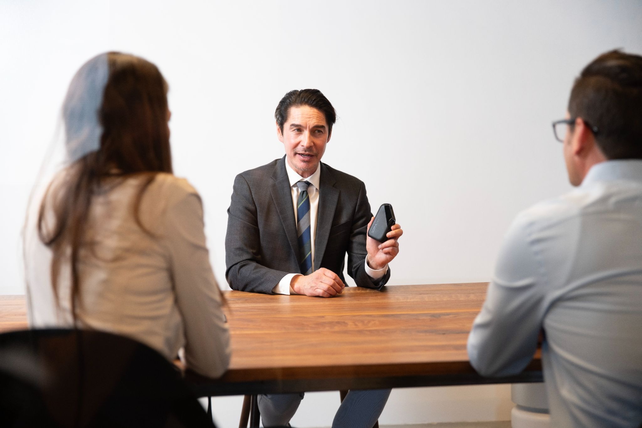 A man and woman meeting with their attorney.