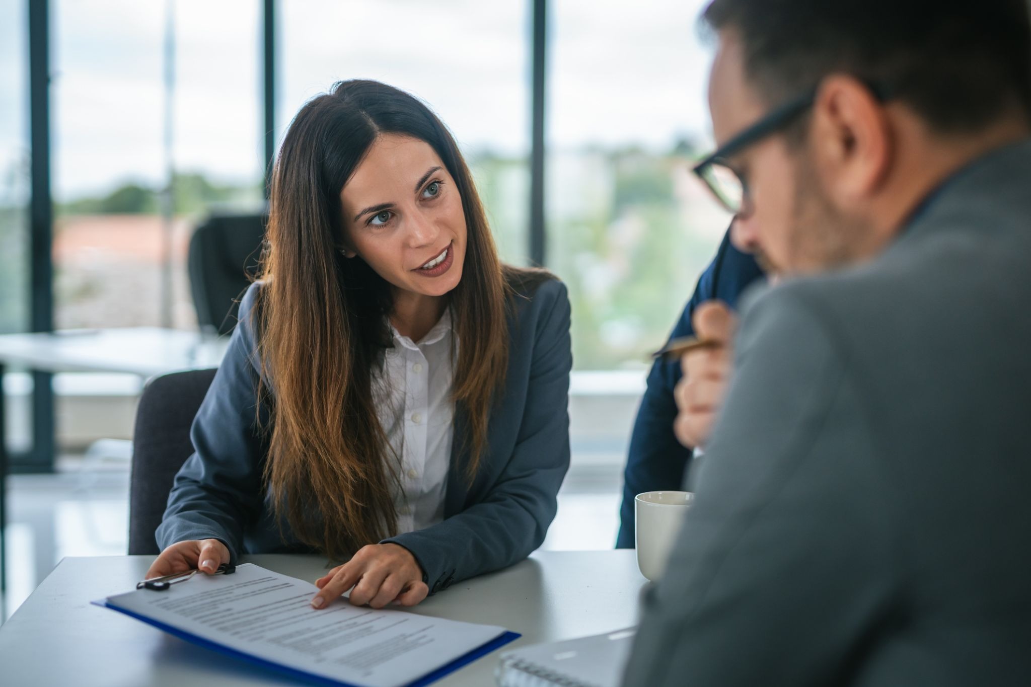 A woman and man reviewing a document.