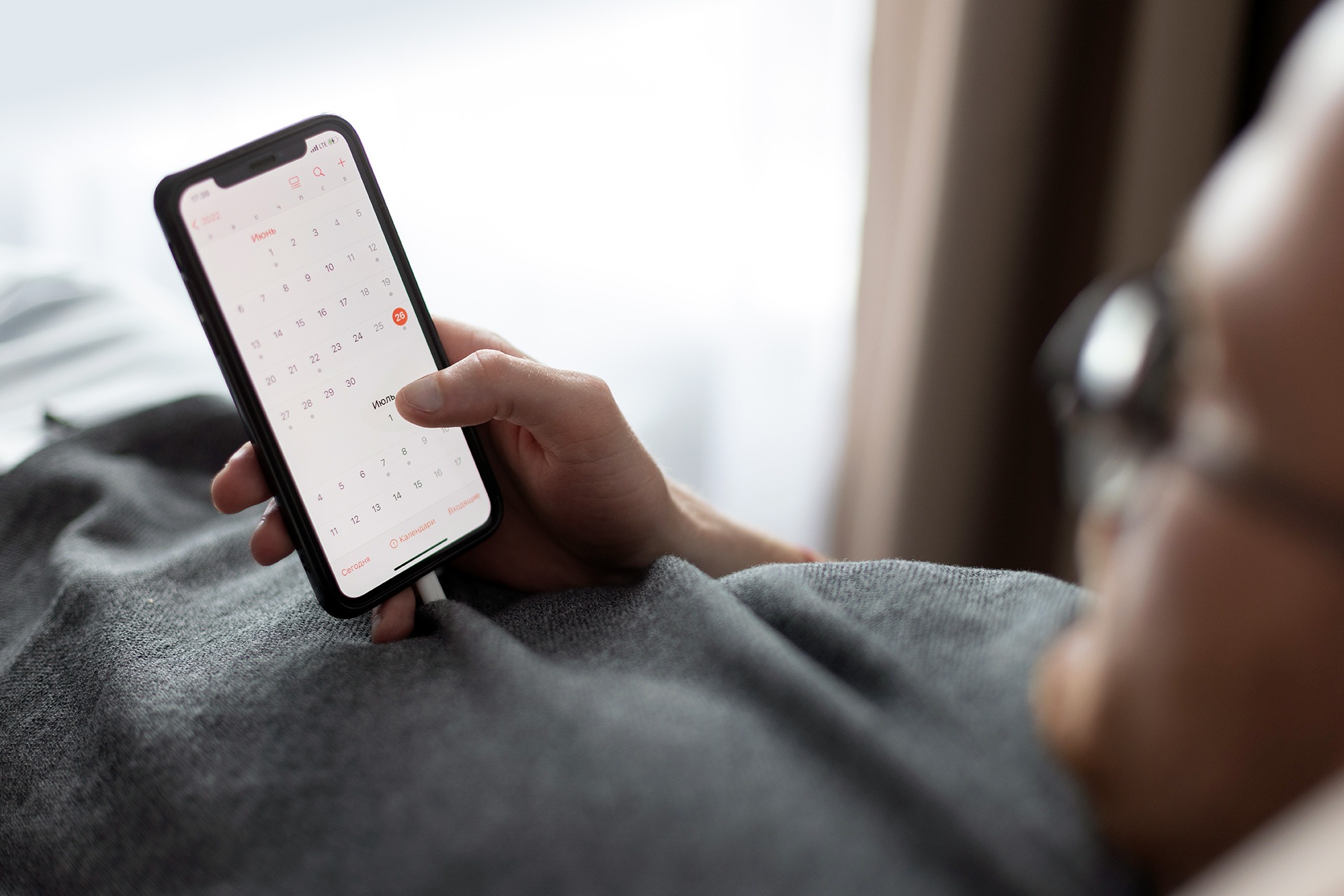 A man checking the calendar on his phone.