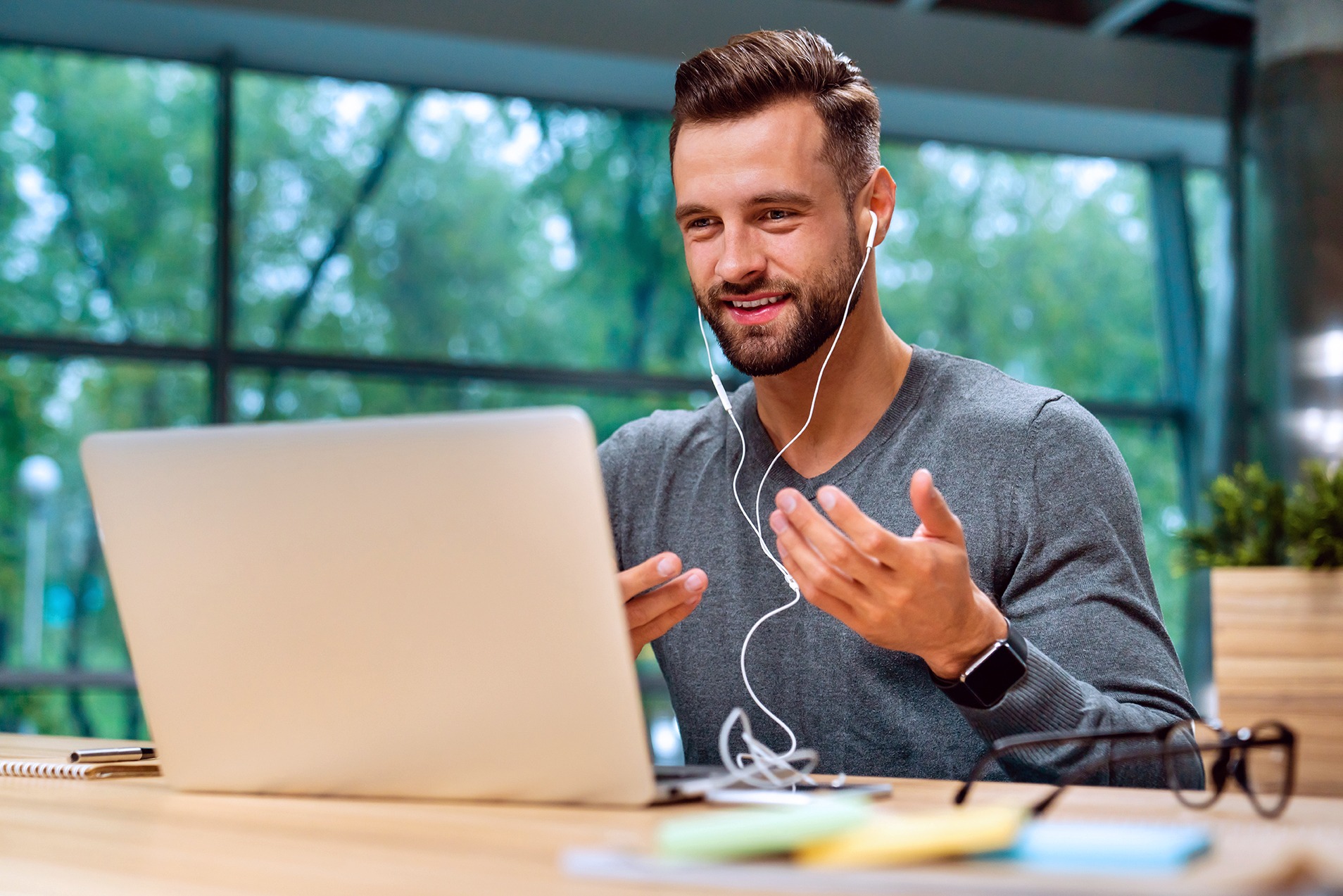 A man sitting in front of his laptop.