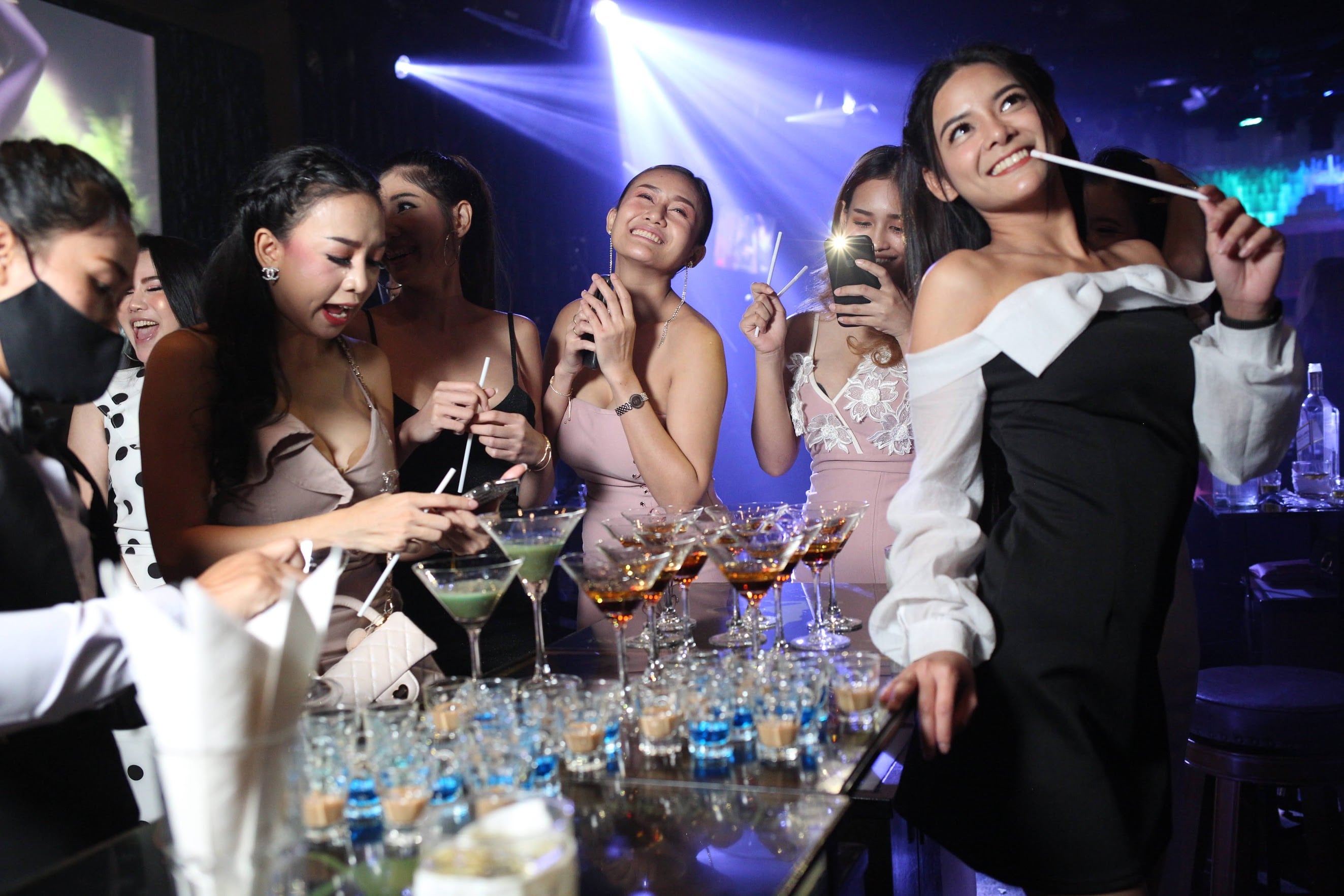 Thai party models drinking at a table at The PIMP Bangkok