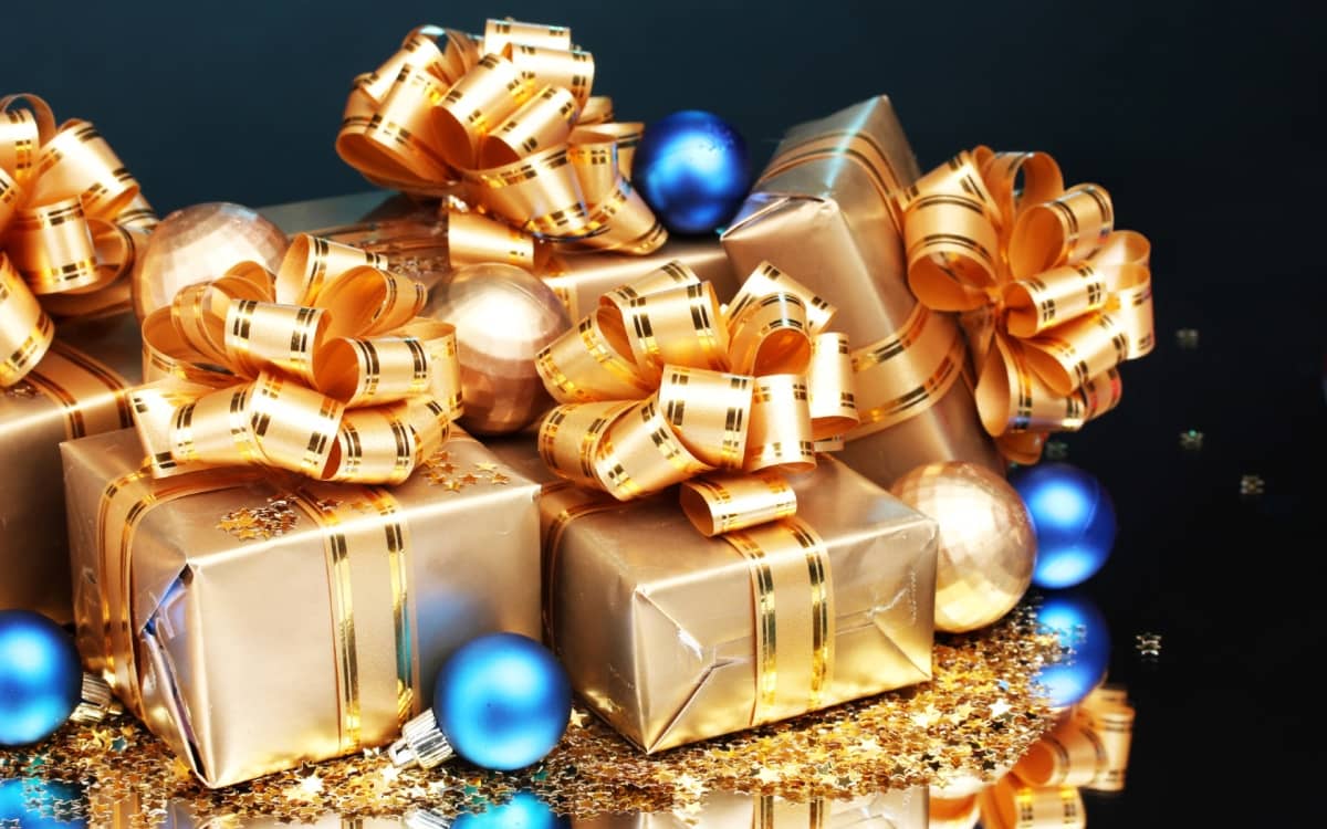 gifts wrapped in gold paper and covered with gold ribbons
