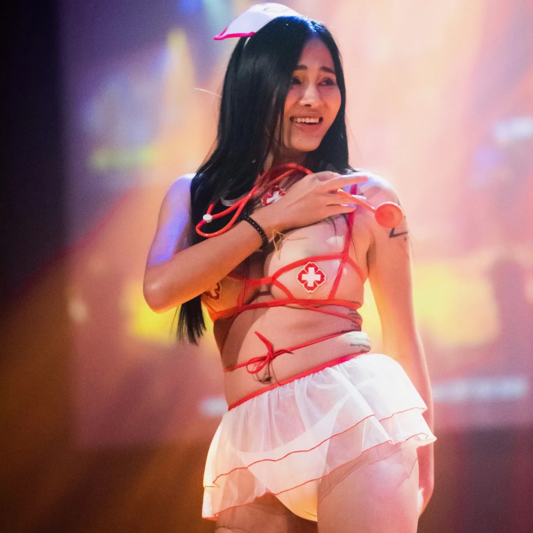 PIMP Thai nurse dancing and smiling on stage at The PIMP Bangkok g club
