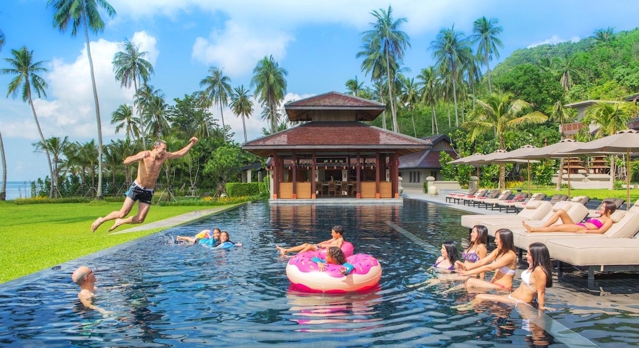 man jumping in a pool at a luxury villa in Thailand