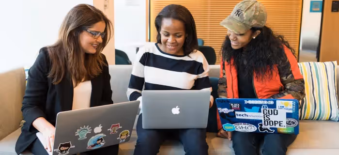 Three female employees developing new skills