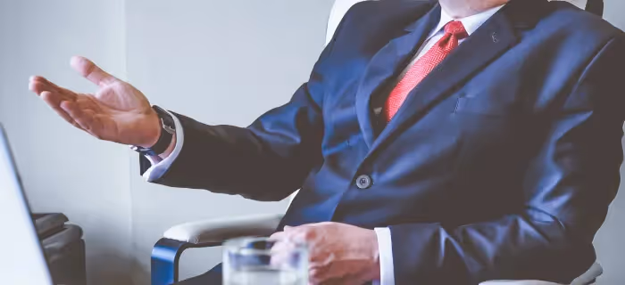 A senior leader giving advice from behind his desk