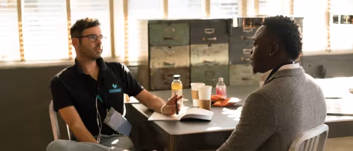 Two male employees having a one to one meeting
