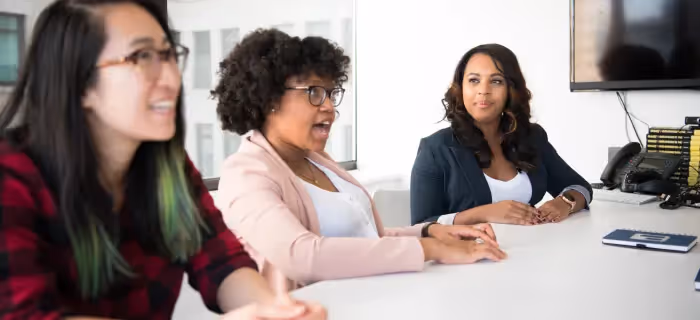 Three employees involved in a discussion