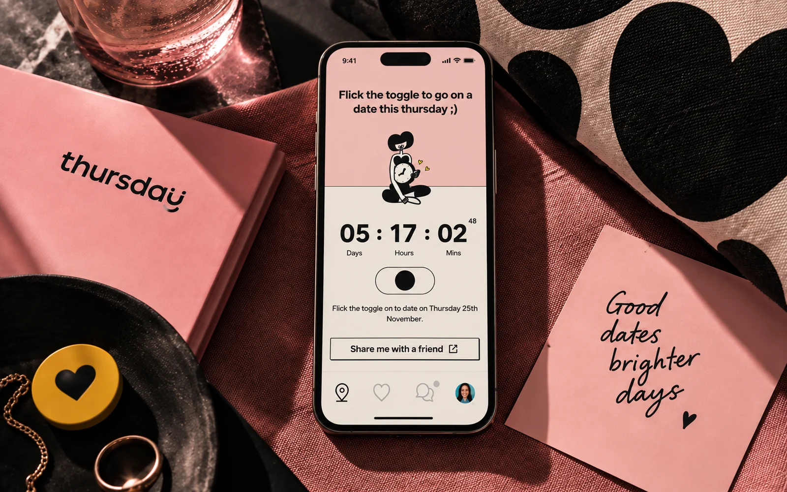 Thursday dating app on a phone surrounded by pink printed materials.
