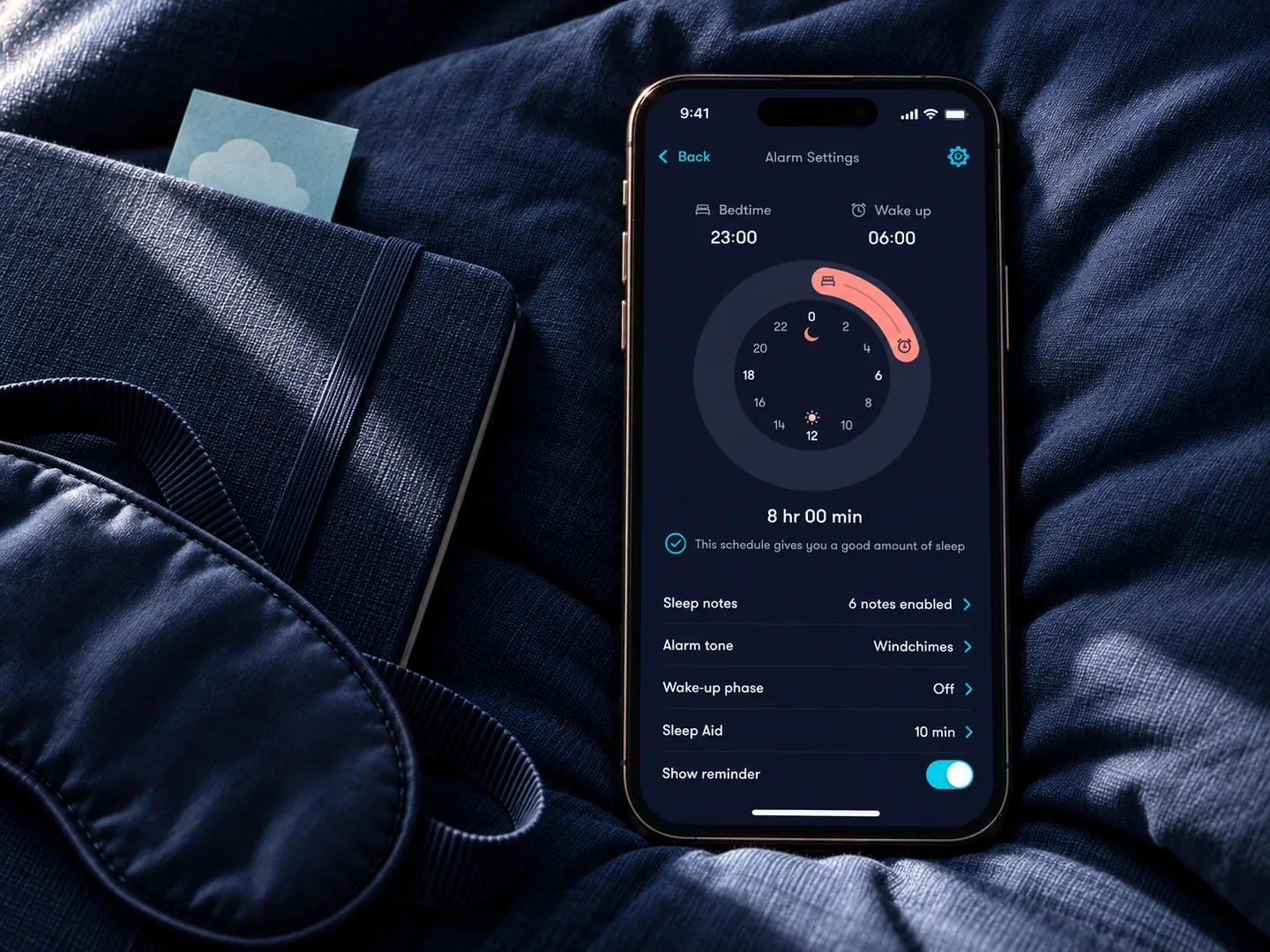 Simba Sleep alarm settings displayed on a phone beside a sleep mask and branded card