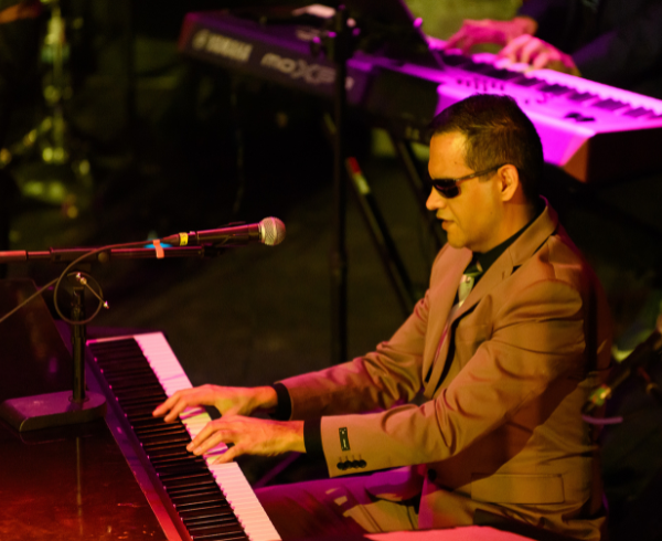 ReelMusician sings while another plays the saxophone