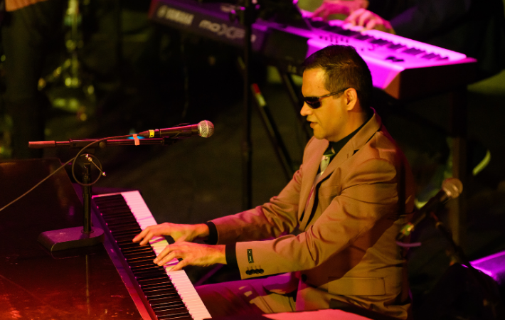 ReelMusician sings while another plays the saxophone