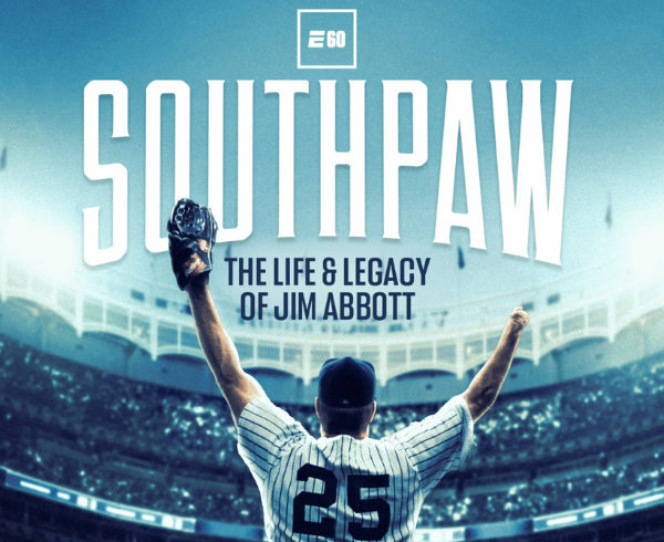 Jim Abbott standing in yankees uniform in stadium with arms above head