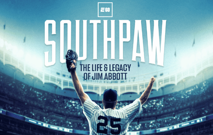 Jim Abbott standing in yankees uniform in stadium with arms above head