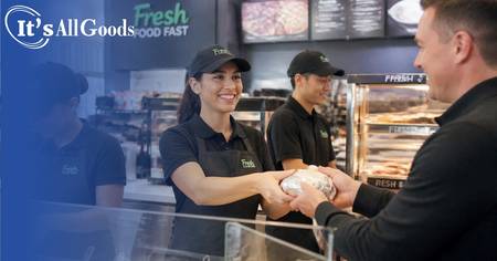 Convenience store worker serving a customer.