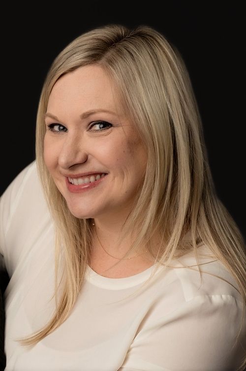 Doctor Kim, standing in a field and smiling