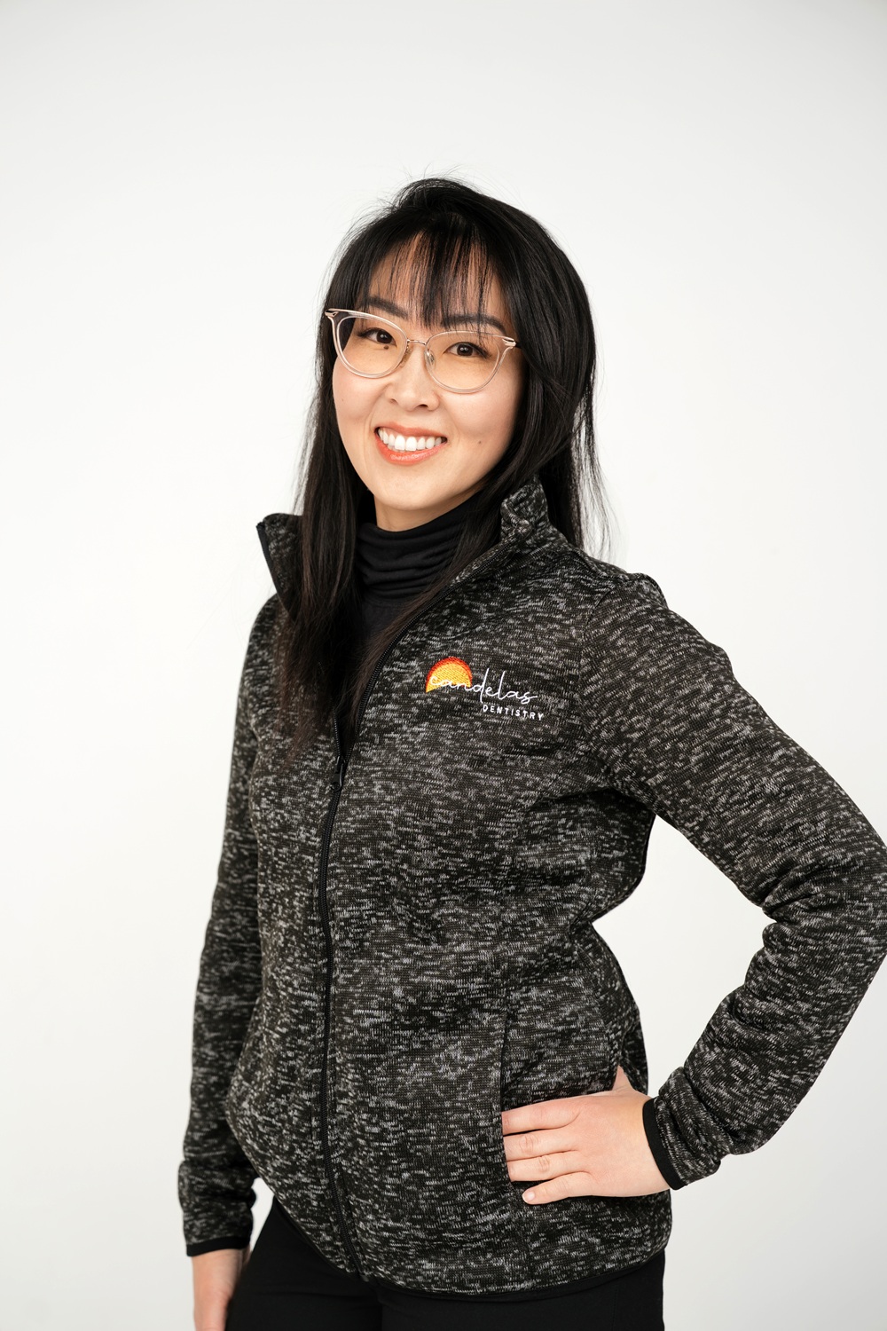 Doctor Kim, standing in a field and smiling