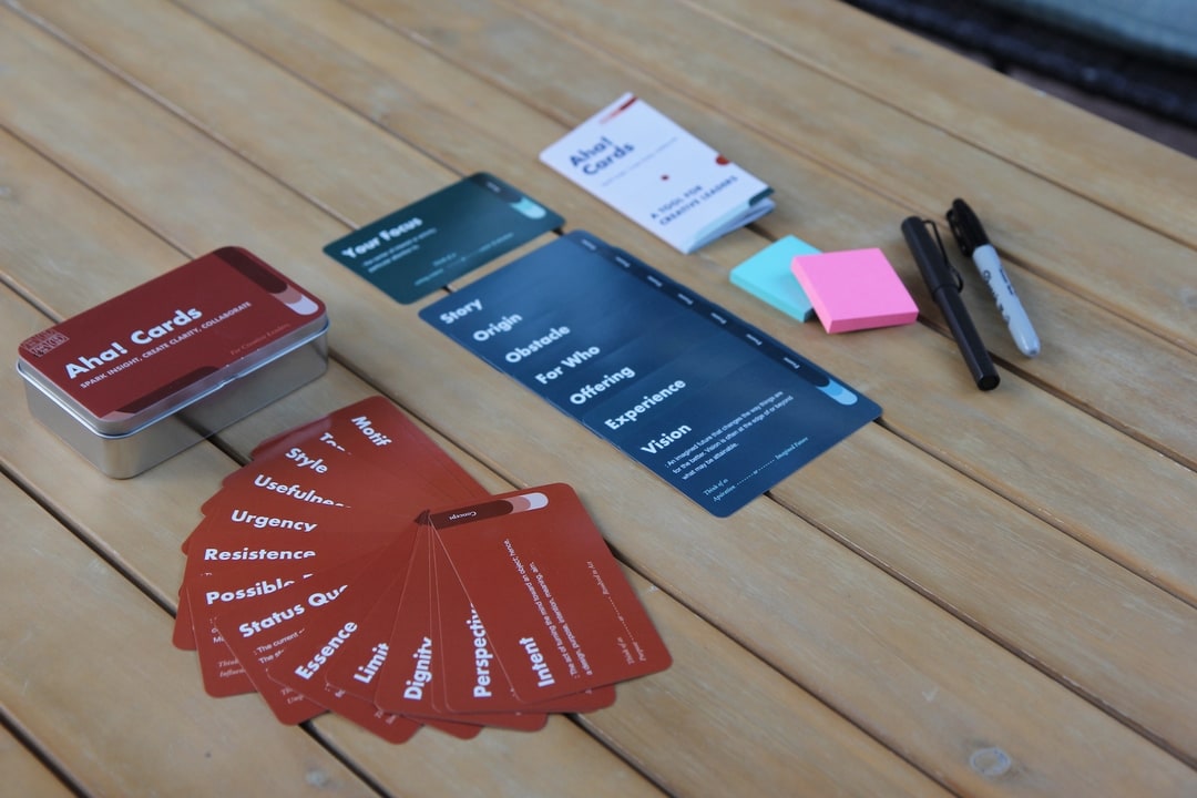 Creative Aha Cards are laid out on the table.  Creative workshop cards and sticky notes.