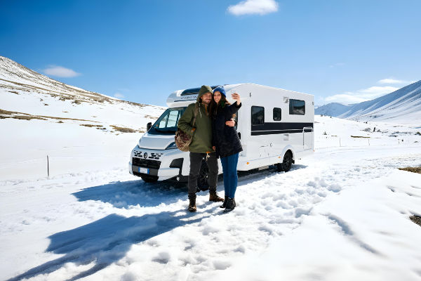 Couple making a selfie infront of a mobile home