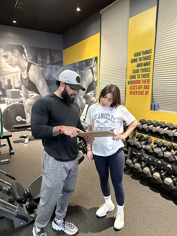 UTG trainer reviewing a custom fitness plan with a client