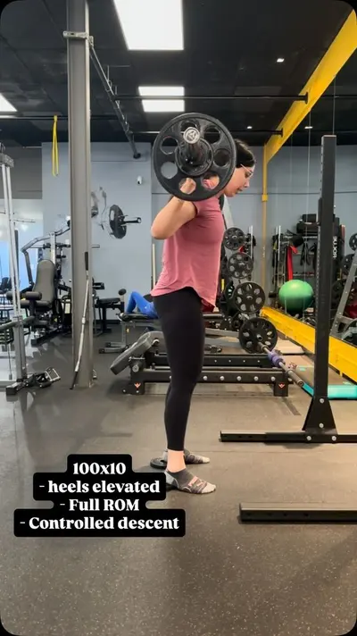 Personal training client performing a barbell back squat at UTG in Westwood NJ