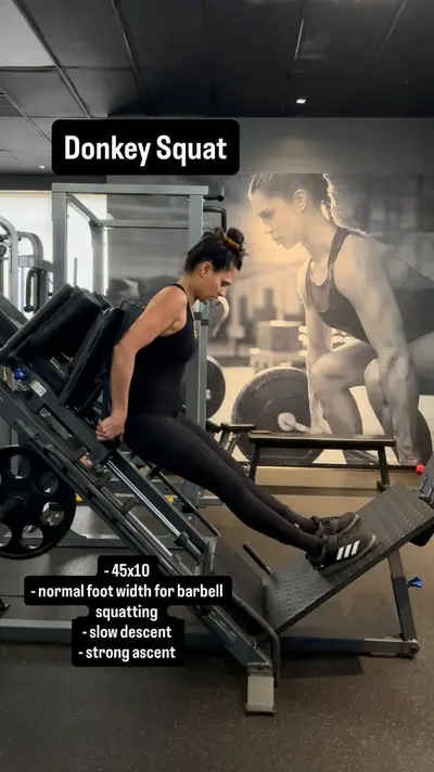 Client performing a machine squat at UTG Personal Training in Bergen County NJ