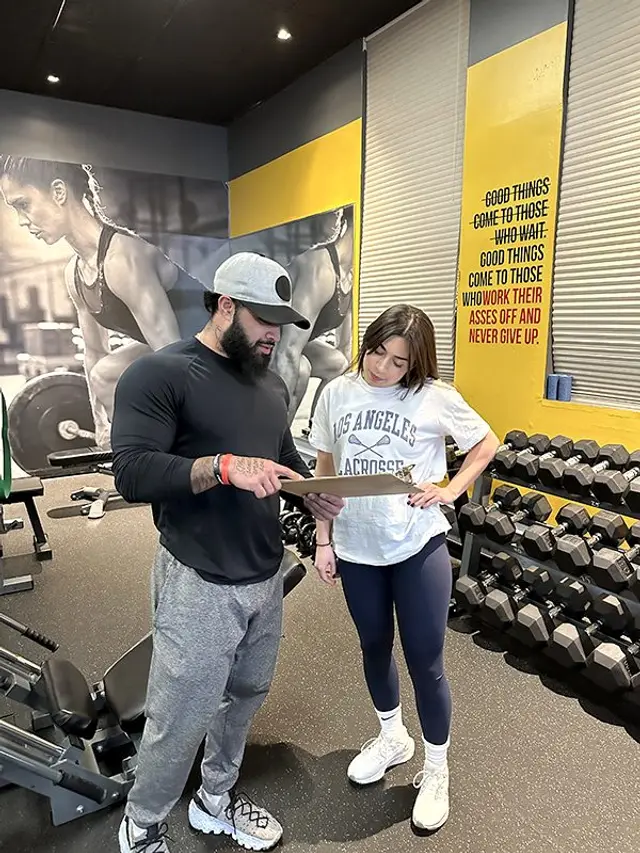 UTG trainer reviewing a custom fitness plan with a client
