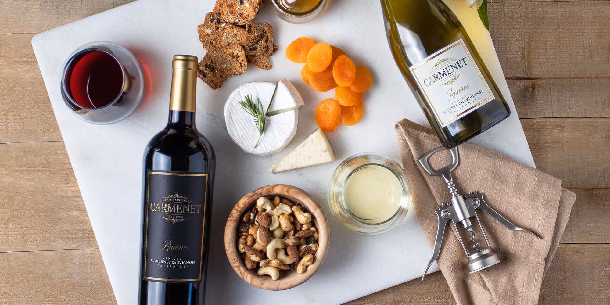 Bottles of Carmenet Cabernet Sauvignon and Carmenet Chardonnay on a marble cutting board
