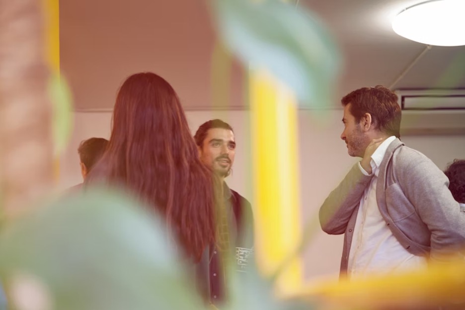 Three people talking to each other. 