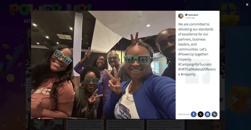 A group of colleagues poses for a fun selfie, wearing branded sunglasses, with their image displayed on a social wall promoting Insperity's #PowerUp campaign.
