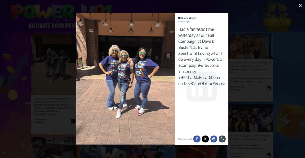 Three women in matching "Power Up and Level Up" t-shirts pose confidently outside Dave & Buster’s, with their photo featured on a social wall showcasing their enthusiasm for Insperity's Fall Campaign.