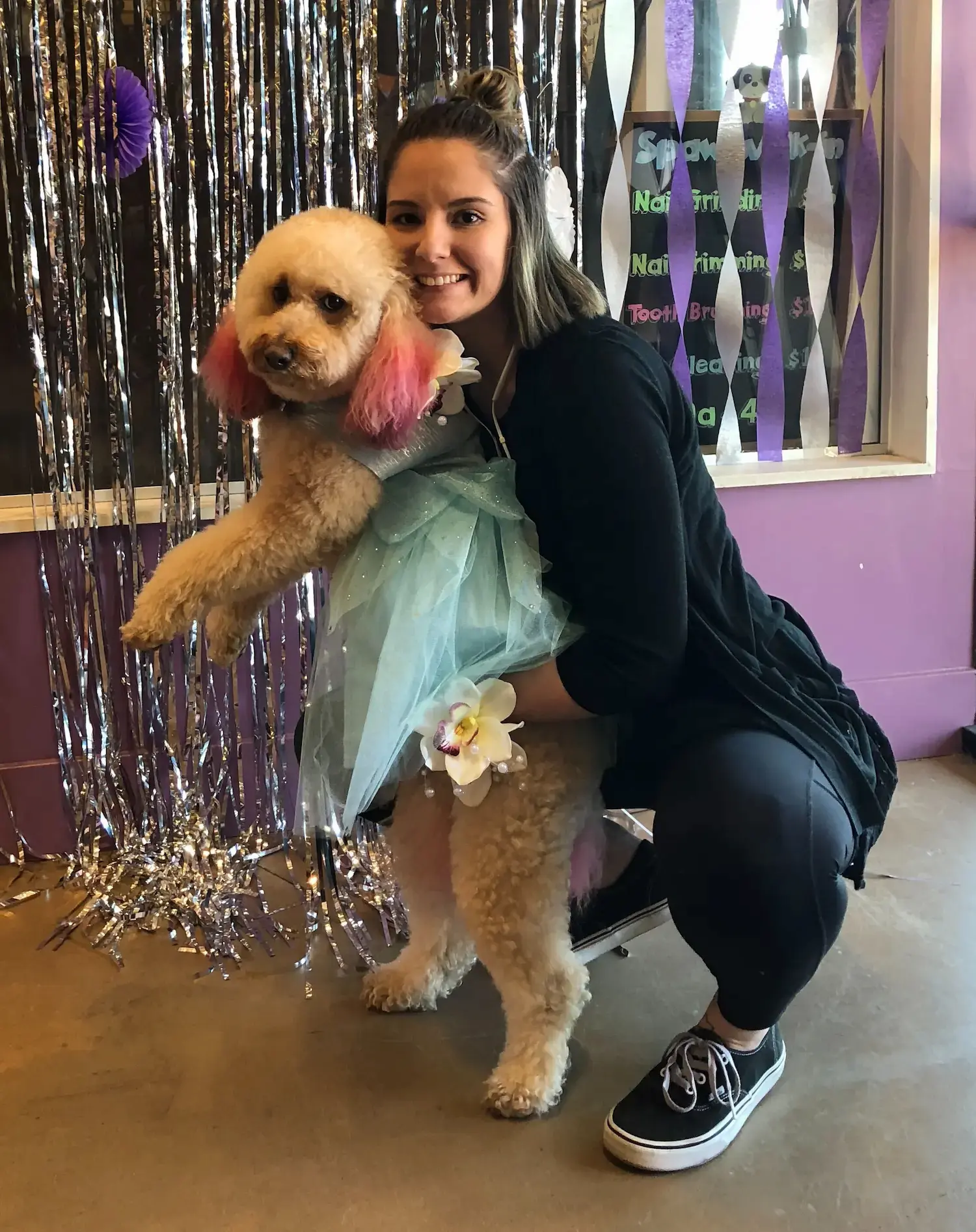 happy groomer with fluffy dog 