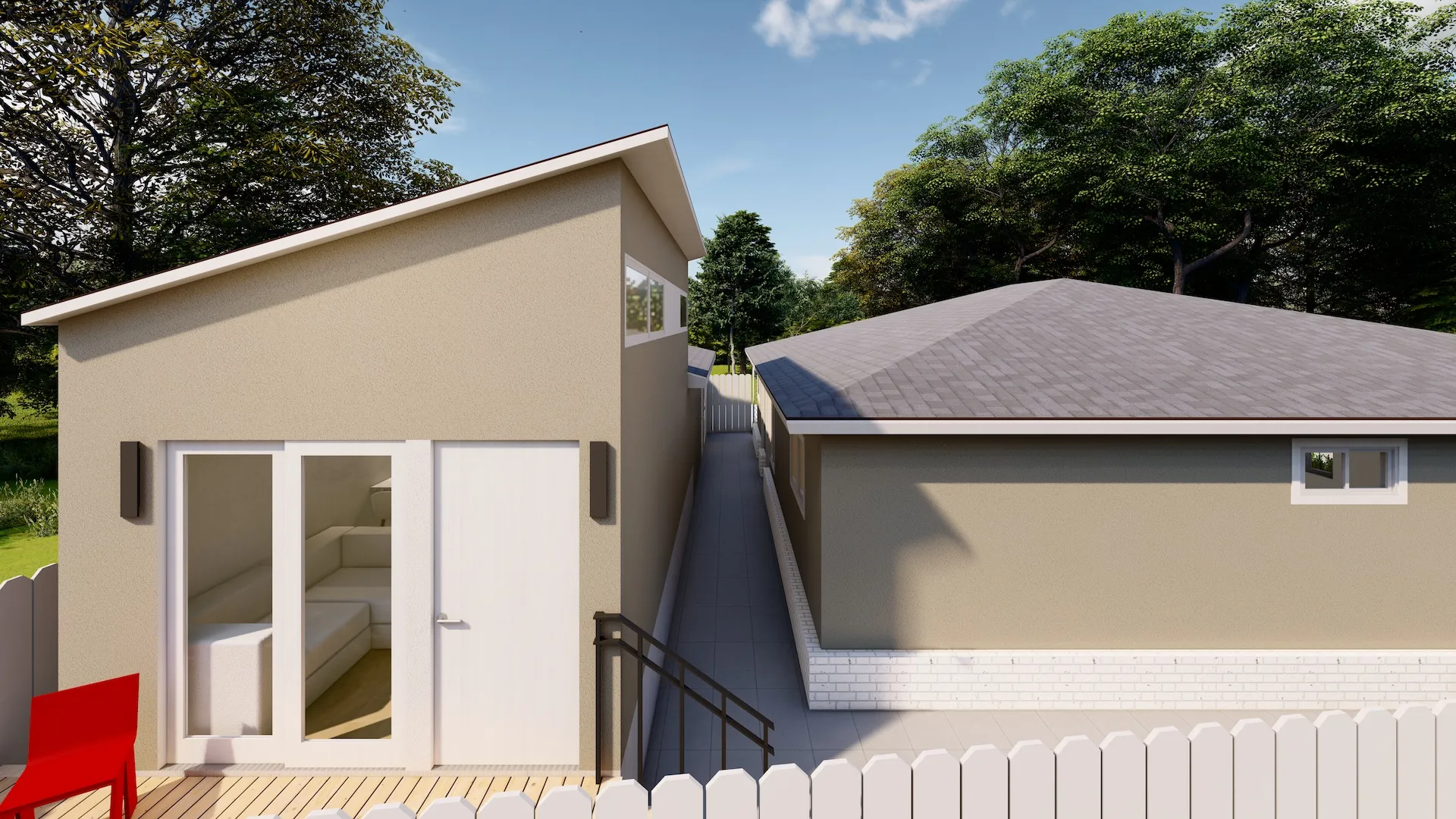 Modern accessory dwelling unit with beige walls, sliding glass doors, small staircase, red chair, and a narrow path between two buildings.