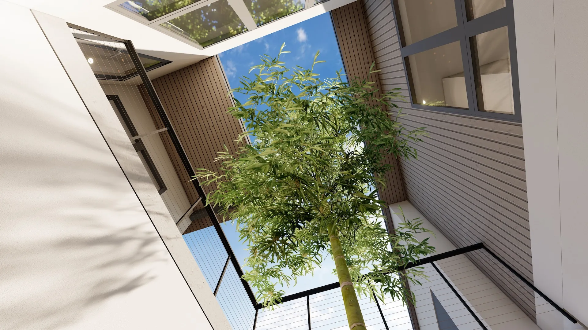 View looking up at a tall bamboo plant inside a modern courtyard with a blue sky visible through an open roof.
