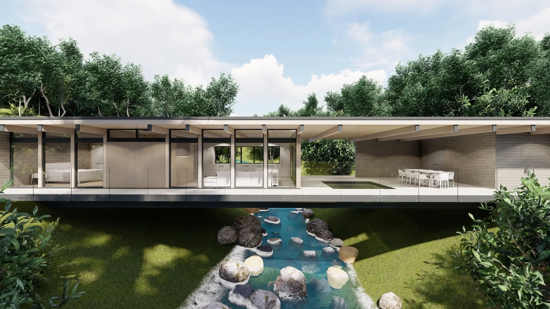 Modern open-concept house with floor-to-ceiling windows overlooking a stream with rocks and surrounded by greenery.