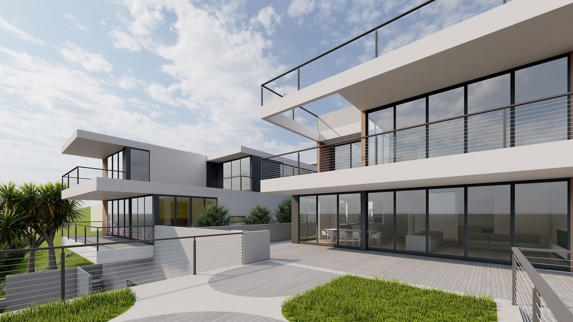 Modern multi-level house with large glass windows, balconies, and outdoor patio area with railing and greenery.