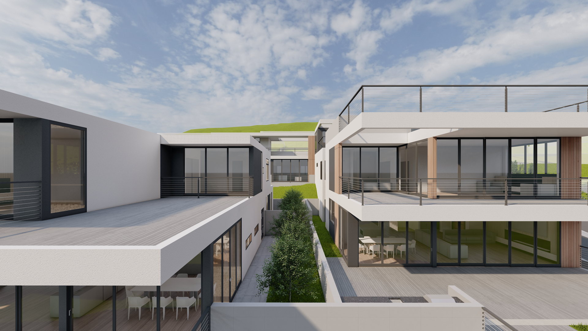 Modern white residential buildings with large glass windows, balconies, and a landscaped walkway with small trees under a partly cloudy sky.